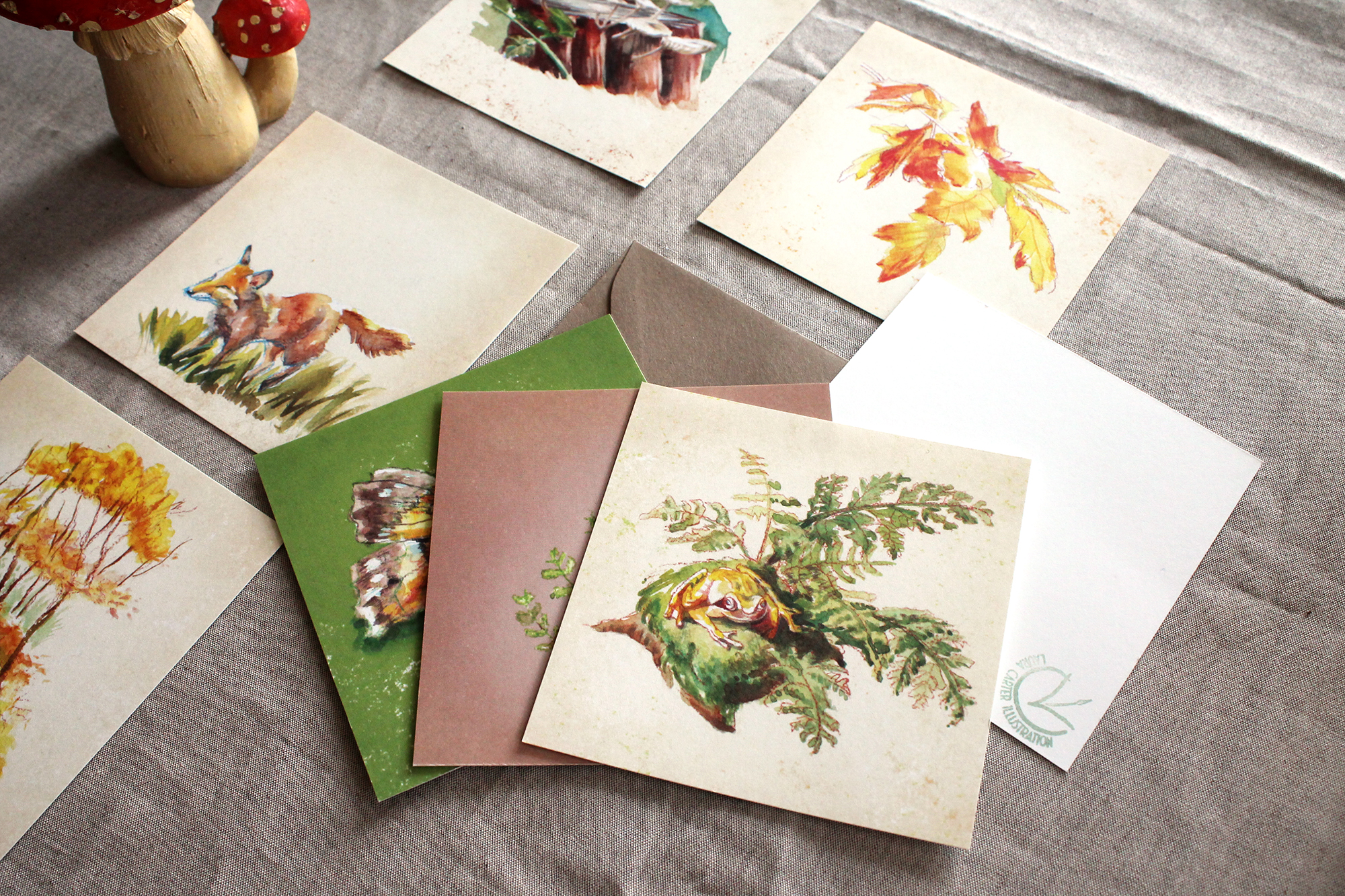 Forest friend painted card set laid out on cloth